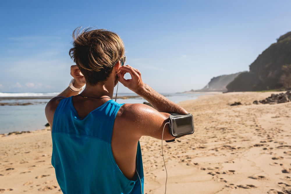 man on the beach listen to music